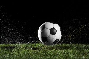 Soccer ball in motion over grass